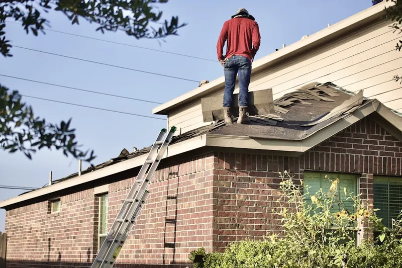 Professional roofer working on a residential roof in Dry Top